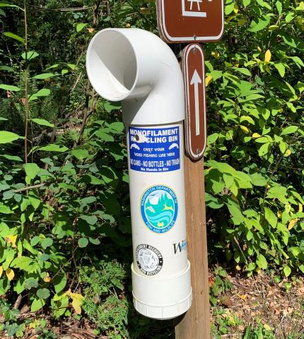 A monofilament recycling bin attached to a sign post, Deep Lake, WA